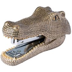 a close up of a metal alligator head with a stapler in it's mouth