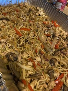 a metal pan filled with noodles and vegetables