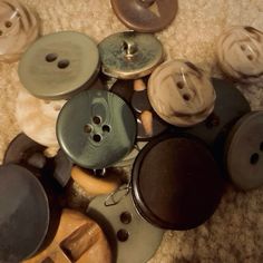 a pile of buttons sitting on top of a carpet