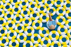 a person laying on top of a blue and yellow mat with circles around it's surface