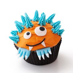 an orange cupcake with blue frosting and spiky spikes on it's face