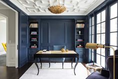 an office with blue walls and white carpeting is featured in the cover of houzz magazine