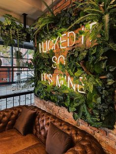 a couch sitting in front of a green wall with the words'kicked it so its mine'written on it