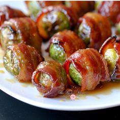 bacon wrapped brussel sprouts on a white plate