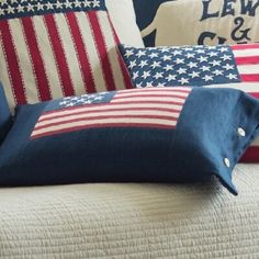 the american flag pillows are on top of the bed