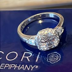 a diamond ring sitting on top of a blue box with the words corbi epiphany