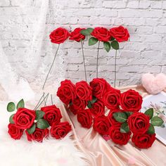 a bunch of red roses sitting on top of a table