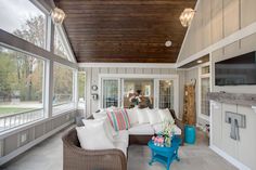 a living room filled with furniture and lots of windows