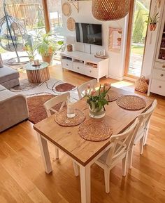 a living room filled with furniture and a wooden table in front of a tv set