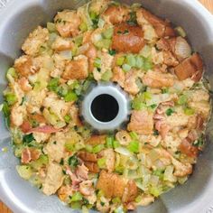 an overhead view of a food processor with meat and vegetables in the bottom portion,