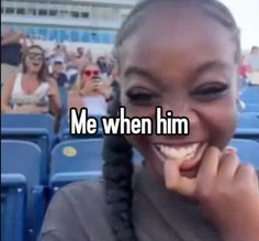 a girl with braids smiling and holding her hand up to her face in front of an audience