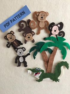 there are some felt animals and palm trees on the wall with a sign that says pop pattern