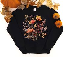 This beautiful Fall Watercolor Wildflower Sweatshirt is great for fall or anytime you need an artistic reminder change is beautiful! The design features a whimsical watercolor autumn wildflowers. Purchase for yourself or as a gift for your favorite autumn or nature lover. Ideal for any situation, a unisex heavy blend crewneck sweatshirt is pure comfort. These garments are made from polyester and cotton. This combination helps designs come out looking fresh and beautiful. The collar is ribbed knit, so it retains its shape even after washing. There are no itchy side seams on these sweaters.  .: 50% cotton, 50% polyester .: Medium-heavy fabric (8.0 oz/yd² (271.25 g/m .: Loose fit .: Sewn-in label .: Runs true to size Autumn Wildflowers, Wildflower Sweatshirt, Change Is Beautiful, Flowers Autumn, Fall Shirts Women, Whimsical Watercolor, Fall Flower, Fall Watercolor, Fall Shirt