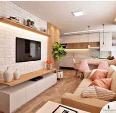 a living room filled with furniture and a flat screen tv mounted on a wall above a fireplace