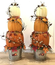 two pumpkins are stacked on top of each other