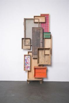 an art piece made out of wooden boxes and crates