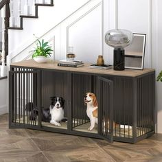 two dogs are sitting in their kennels under the stair case on the floor