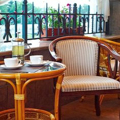 two chairs and a table with cups on it