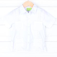 Don't forget to pack this Solid White Guayabera for your next resort vacation this summer or Cinco de Mayo celebration! It features four front pockets and pleated details. Personalize this short sleeve Guayabera shirt for your toddler boy or big kid by adding a monogram. *Please note the pocket will be sewn shut if a monogram is added. White Summer Camp Shirt With Pockets, Summer White Camp Shirt With Pockets, Vacation Camp Shirt With Pockets And Short Sleeves, White Short Sleeve Beach Shirt With Pockets, White Short Sleeve Shirt With Pockets For Beach, Fitted Collared Short Sleeve Shirt For Beach, Fitted Collared Short Sleeve Beach Shirt, Solid Summer Camp Shirt With Pockets, Classic Beach Tops With Pockets