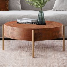 a living room with a couch, coffee table and flowers