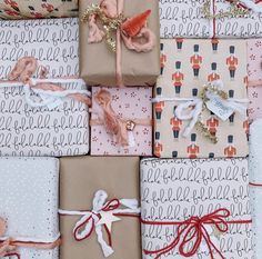 several wrapped presents with bows and ribbons on top of each other in various patterns, sizes and colors