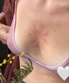 a close up of a woman's breast with tattoos on it