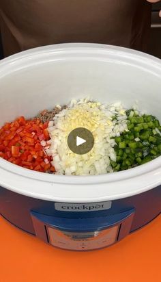 the food is being prepared in the crockpot on the orange tablecloths