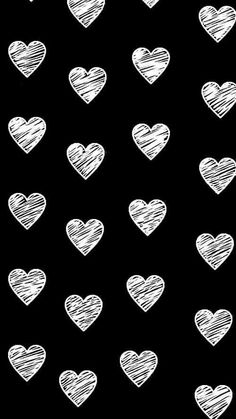 white hearts drawn in chalk on a black background