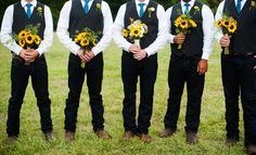 a group of men standing next to each other holding bouquets of sunflowers