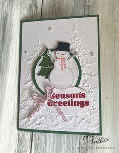 a card with a snowman on it and the words season's greetings