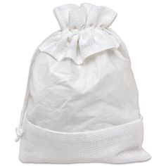 a white bag with a bow on the front and bottom side, sitting on a white surface