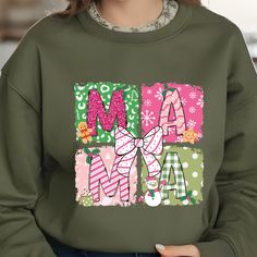 Celebrate the holiday spirit with this fun and festive "MAMA" design! Featuring vibrant colors and creative details, this piece combines comfort and style to enhance your holiday wardrobe. Product Features: High Quality: Made from durable, soft, and comfortable fabric, ideal for daily wear during the holiday season. Unique Design: Showcasing a cheerful "MAMA" theme with holiday-inspired details for a standout style. Size Options: Available as a shirt, sweatshirt, or hoodie in sizes S to XXL, ensuring a perfect fit for everyone. Easy Care: Machine washable with vibrant, long-lasting prints to keep your holiday style fresh. Note: Slight color variations may occur due to lighting and device settings. Personalization Available: Want to make it more special? Contact us to explore customization Mama Design, Xmas Shirts, Mama Shirts, Family Christmas Shirts, Mama Sweatshirt, Christmas Mom, Holiday Wardrobe, Mom Sweatshirt, Sweatshirt Christmas