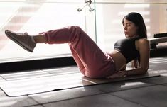 a woman is laying on the floor with her legs crossed and feet up in the air