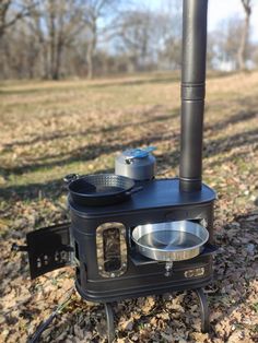 an outdoor stove is set up in the leaves