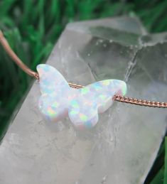 "Simple. Chic. Minimalist™ A perfectly dainty brilliant synthetic White opal butterfly stone is hanging on a delicate feminine Sterling silver chain. Opal butterfly measures 11mm. It has a Snow white color with glints of turquoise and pink. Model is wearing 16\" length Also available with Caribbean blue opal color Also available with 14K Gold filled/ 14K Rose gold filled chain. ❤️ Personalize it! Add a tiny letter charm to the clasp- https://www.etsy.com/listing/240726946/add-a-personalized-lett White Adjustable Butterfly Necklace For Gift, White Butterfly Necklace With Adjustable Chain, White Butterfly Necklace With Adjustable Chain As Gift, White Butterfly Necklace With Adjustable Chain For Gift, White Adjustable Butterfly Charm Necklace, White Butterfly Necklace With Delicate Chain, Dainty White Butterfly Necklace, Sea Blue Color, Turquoise And Pink