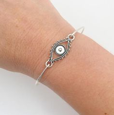 Evil Eye Bracelet - Evil Eye JewelryA detailed silver tone evil eye charm will be transformed into a beautiful evil eye bracelet with bangle band choice of silver filled or sterling silver.Also available with a gold tone evil eye and bangle band choice of brass or 14k gold filled band. If you want this option for your evil eye bracelet bangle, select from options when ordering.This evil eye bracelet looks great stacked with other bangles from my collection as you can see from the last 4th pictur Turkey Jewelry, Protection Bracelet, Turkish Jewelry, Shell Bracelet, Blue Evil Eye, Evil Eye Charm, Evil Eye Bracelet, Hamsa Hand, Birthstone Charms