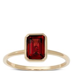 A high polish band presents a bezel set rectangle cut garnet for a sweet pop of color. The band is approximately 1mm wide. 14k Gold Jewelry With Bezel Set Rectangular Stone, 14k Gold Ring With Bezel Setting And Rectangular Stone, 14k Gold Ruby Ring With Bezel Setting, Emerald Cut, Classic Rectangular Ruby Promise Ring, Emerald Cut Red Birthstone Ring In 14k Gold, Elegant Rectangular Ruby Ring In 14k Gold, Elegant Ruby Ring With Rectangular Polished Finish, Elegant Rectangular Ruby Ring With Polished Finish, 14k Gold Rectangular Rings With Bezel Setting