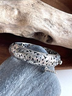 "Sterling Silver Silpada filigree bracelet bangle. This bracelet is aptly named \"Forever Stunning\". It has a classic style to it and can be worn with anything. It features an open-work filigree design, a hinged clasp and a safety chain. Fits wrists up to 7.5\" Additional Information: * Complimentary Gift Box! * All jewelry items come securely packaged and are mailed promptly upon payment - often same-day. * The majority of my vintage items are used and may show some wear. Please review all pho Carved Sterling Silver Bangle, Classic Sterling Silver Bangle With Intricate Design, White Gold Sterling Silver Bangle With Intricate Design, Ornate Sterling Silver Bracelet With Intricate Design For Anniversary, Sterling Silver Bangle With Intricate Design For Anniversary, Ornate Engraved Sterling Silver Bracelet For Anniversary, Silver Filigree Bangle For Gift, Classic Filigree Bangle Gift, Silver Filigree Bangle For Anniversary