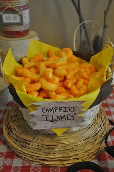 a basket filled with cheetos sitting on top of a table