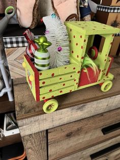 a wooden toy train with christmas decorations in it