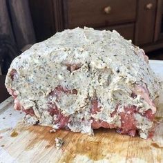 a piece of meat sitting on top of a wooden cutting board