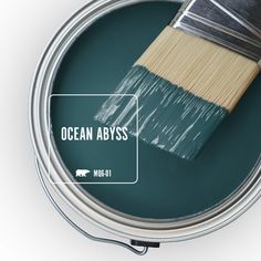 a paint can with a brush in it and the words ocean abyss on top of it