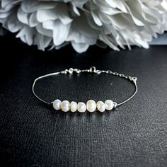 "Lustrous cashmere white Pearls strung on fine sterling silver can be worn as a bracelet or an Anklet. Pearl signifies faith, charity, and innocence. It enhances personal integrity and helps to provide a focus to ones attention. Pearl symbolizes purity and is known as a \"stone of sincerity\". It brings truth to situations and loyalty to a \"cause\". Inhibits boisterous behavior. - 3-5mm Pearls - 3mm Sterling Silver beads - Beads move freely - .5mm Sterling Silver Foxtail Chain - Sterling Silver White Sterling Silver Anklets As Gift, Adjustable Sterling Silver Anklets For Wedding, Adjustable Sterling Silver Wedding Anklets, Elegant Adjustable Anklets For Everyday Wear, Crystal Jewelry Design, Personal Integrity, White Pearl Jewelry, Balance Bracelet, Freshwater Pearl Jewelry