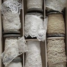 an open box filled with lots of white lace