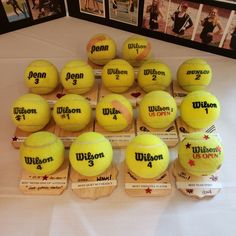 a bunch of tennis balls sitting on top of a table