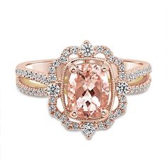 a pink diamond ring with diamonds around it