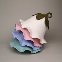 three pieces of fabric are stacked on top of each other in different colors and shapes