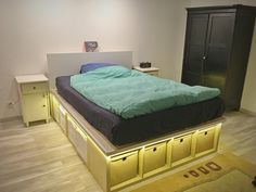 a bed that is sitting on top of a wooden floor next to a night stand