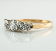 Victorian Ring, Genuine Diamond Ring, 18K Gold Band, Fold Ring, Antique Ring, Engagement Ring, Wedding Ring, This gorgeous diamond band ring is crafted in solid 18K Yellow gold and White gold for diamonds setting. Five round brilliant cut natural diamonds total .86 carat (.40 in the center, 2 x .15cts, 2 x .08cts) of SI2-I2 clarity and HI color. The width of the band on the front is 5mm North-South. The setting raises 5.5mm above finger. Size 7.25 (sizable). The ring weighs 3.9 grams. Good vinta Victorian Diamond Ring With Vvs Clarity, Fine Jewelry Diamond Ring With Brilliant Cut For Marriage, 14k Gold Diamond Ring With Rose Cut For Marriage, Diamond Ring With Accents For Marriage, Diamond Ring With Diamond Accents For Marriage, Marriage Diamond Ring With Diamond Accents, Single Cut Diamond Round Ring For Marriage, Single Cut Diamond Marriage Ring, Heirloom Single Cut Diamond Rings For Marriage