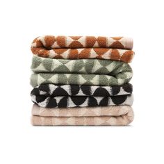 four towels stacked on top of each other in different colors and patterns, with one folded up